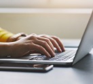 Woman typing on computer